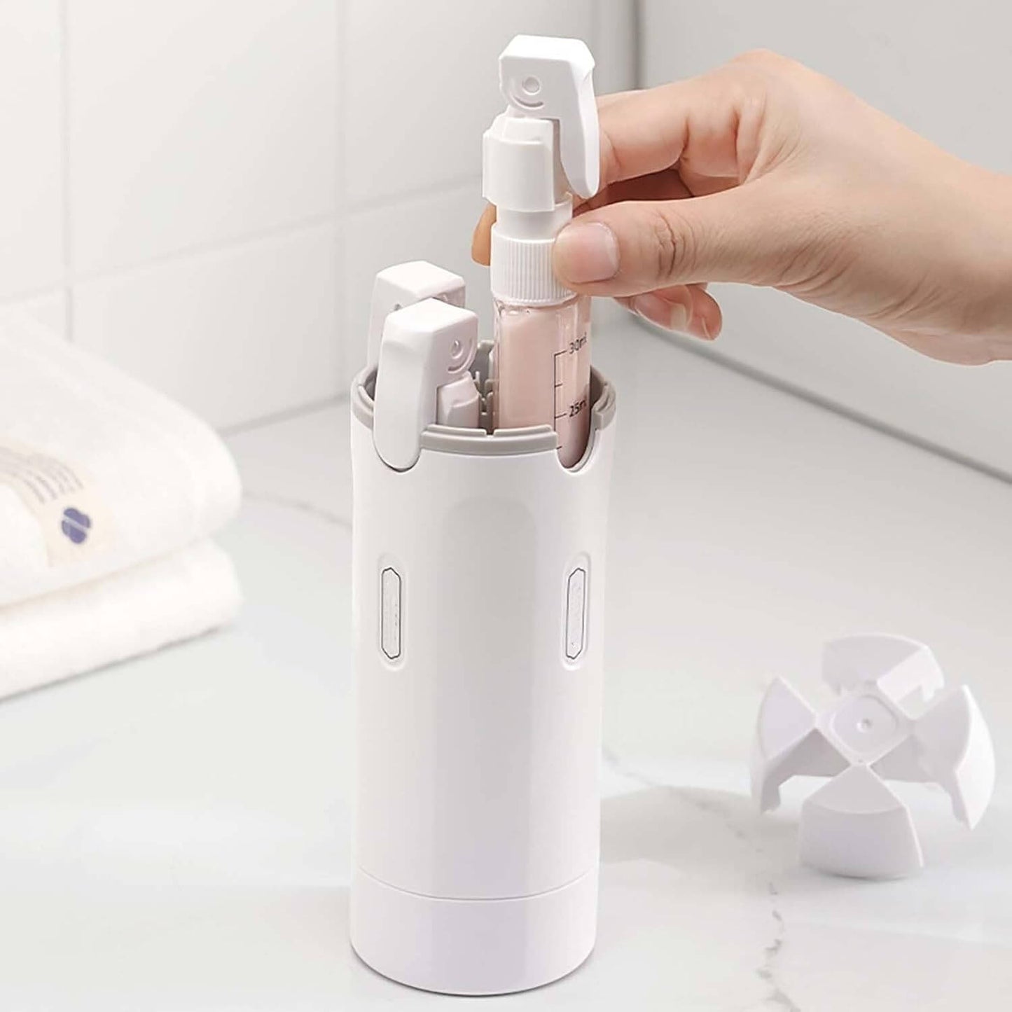 4 In 1 Travel Refillable Leak Proof Bottle Set 30ml compact leak‑proof travel bottles in white case being removed by hand