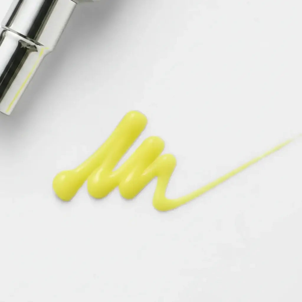 Korean retinol tightening serum yellow cream swatch on a white surface, showcasing its lightweight texture.