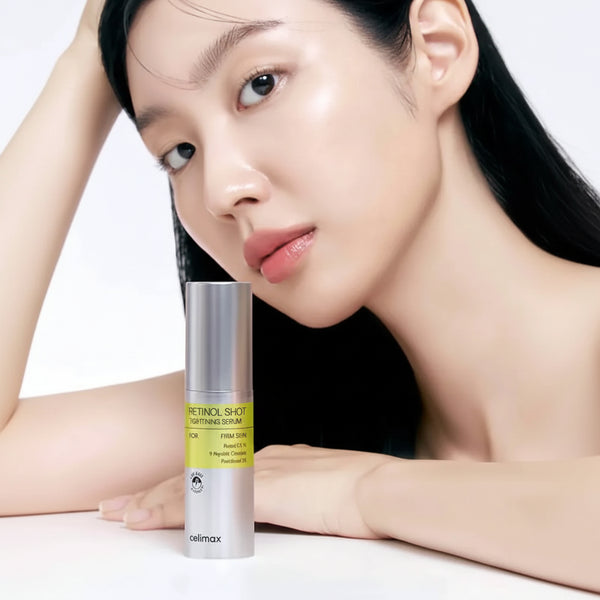 Woman holding a skincare product with a neutral background