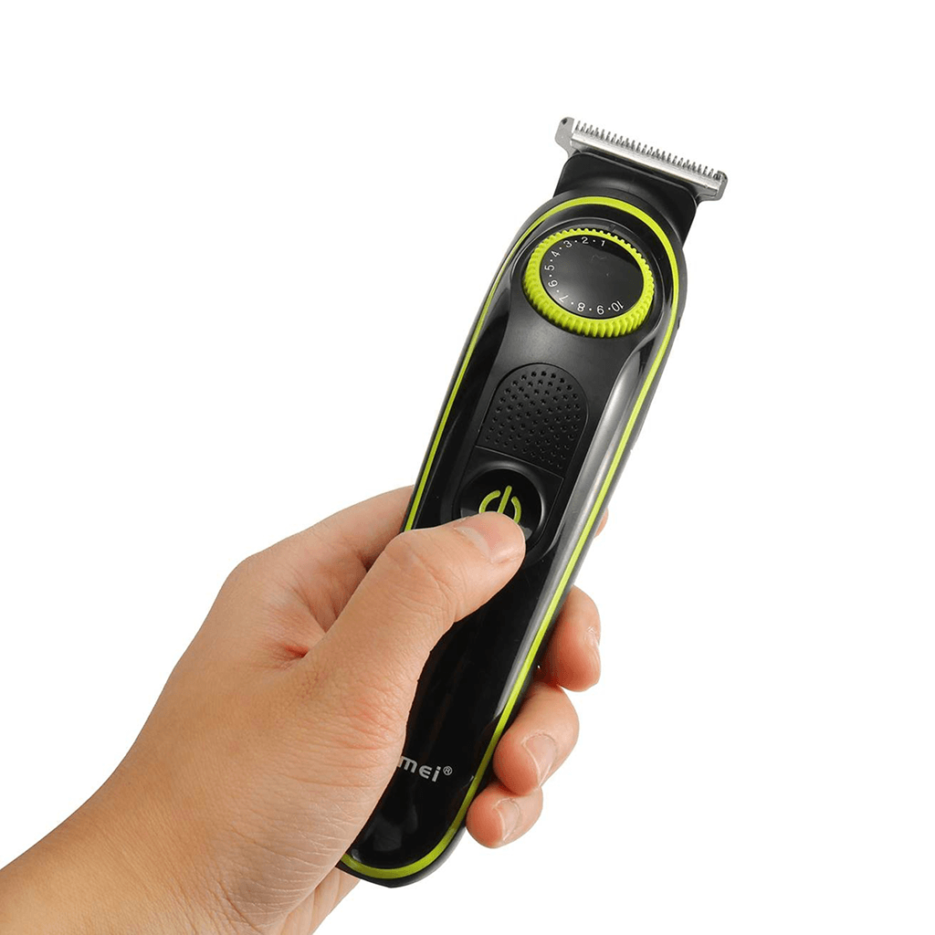 Hair trimmer held in a hand with a white background
