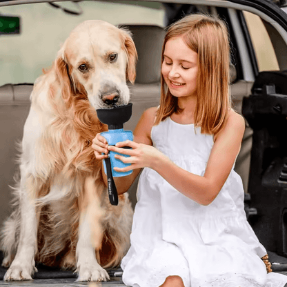 Keep Your Dog Hydrated Anywhere – 520ml Portable Foldable Water Bottle showing girl giving golden retriever water from a blue foldable squeeze bottle