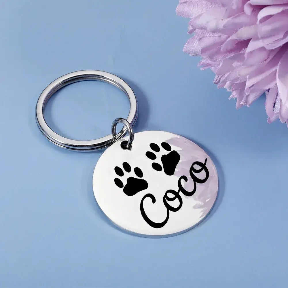 Dog Tag – Permanent Engraving For Legibility + Stainless Steel Quick Release Attachment, round engraved pet tag with paw prints and name "Coco"