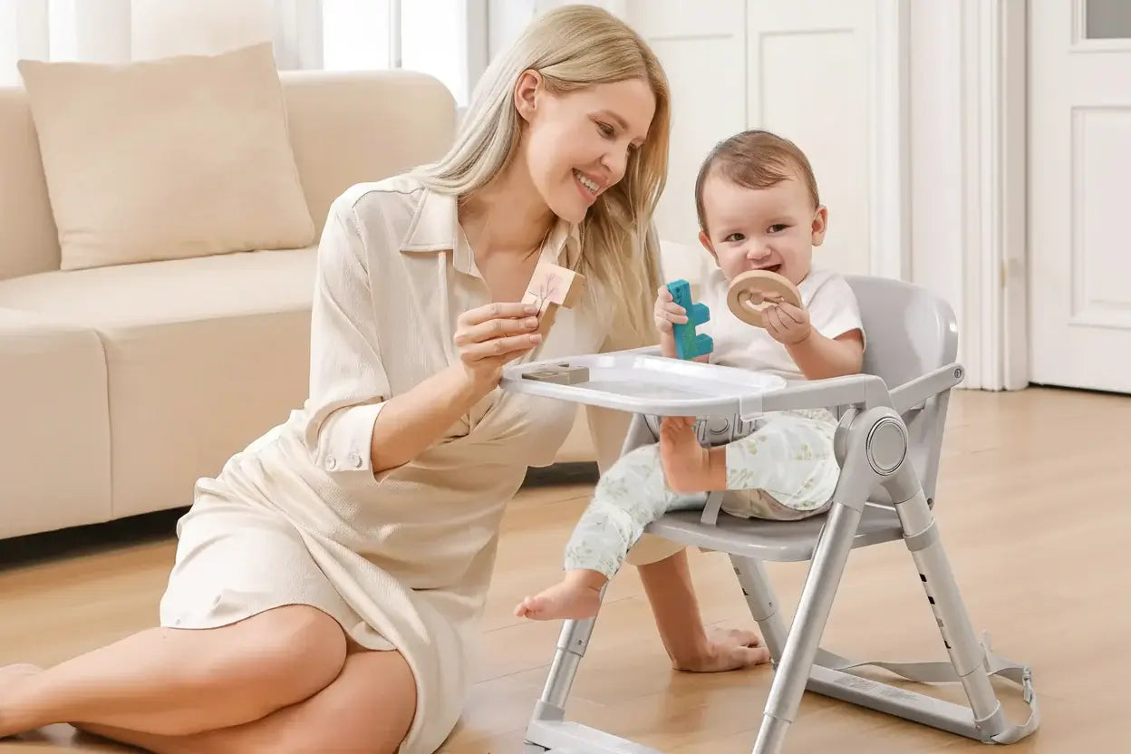 Baby Booster Seat – Mess-Free Dining + Foldable Portable High Chair For 6 Months To 3 Years, mom feeding baby in portable foldable booster high chair
