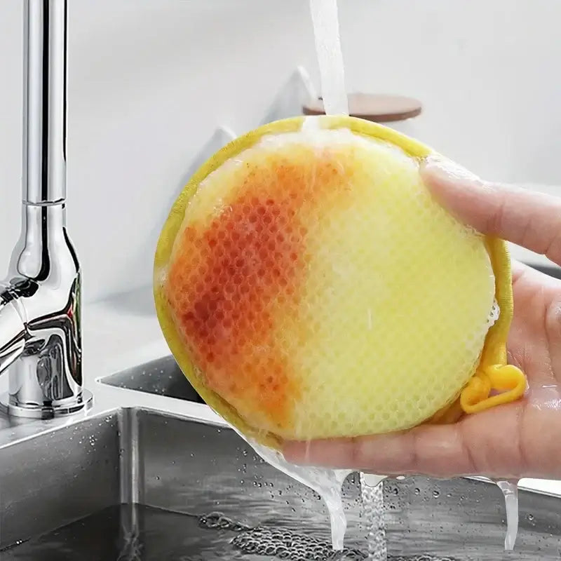 Sponge Scourers – Mess-Free Everyday Cleaning + Dual-Sided Design round yellow sponge scourer rinsed under faucet