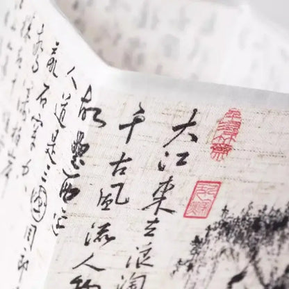 Close-up of a decorative paper with traditional Chinese calligraphy and stamps, showcasing artistry and culture.