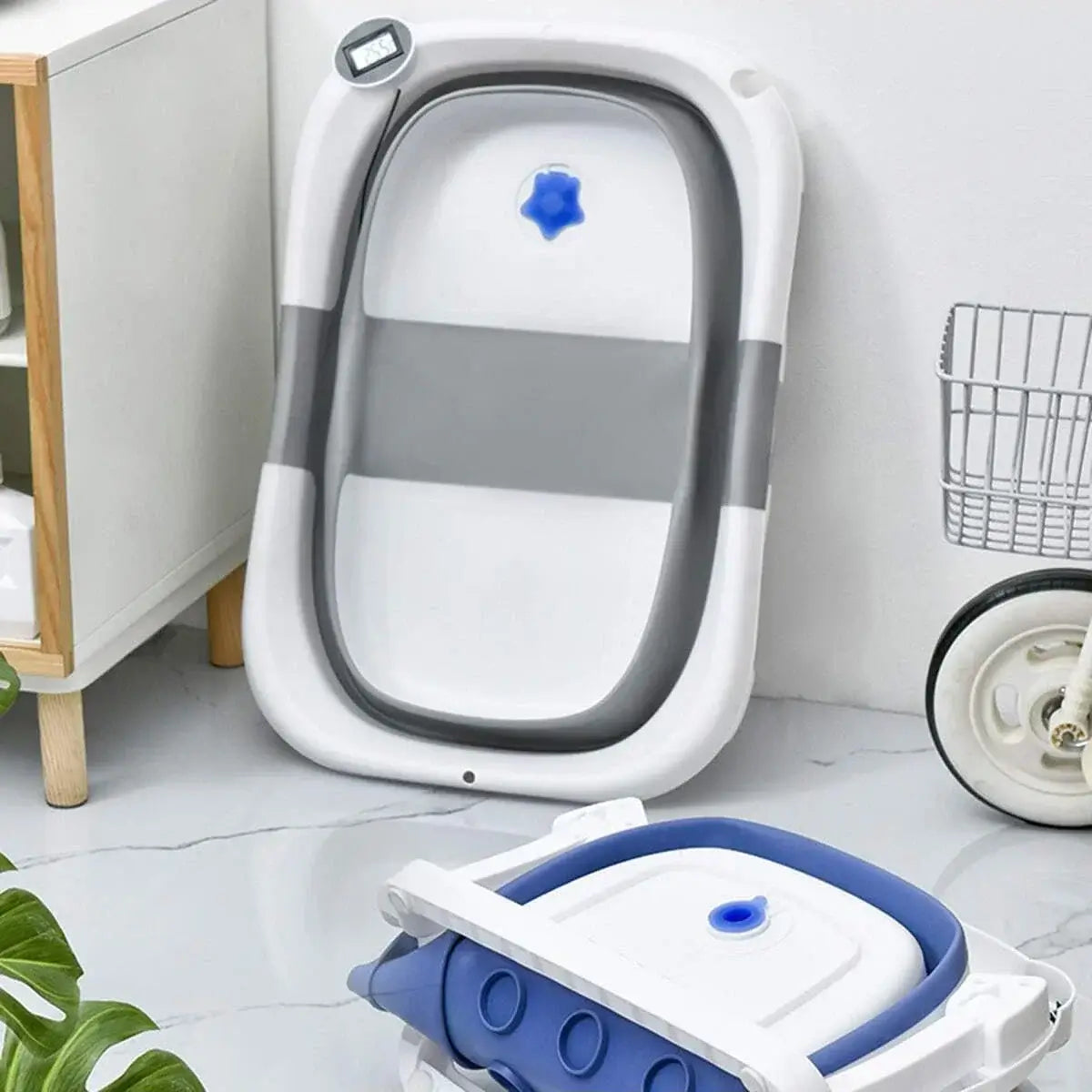 Foldable newborn baby bath tub displayed in a modern bathroom setting, showcasing its compact and space-saving design.