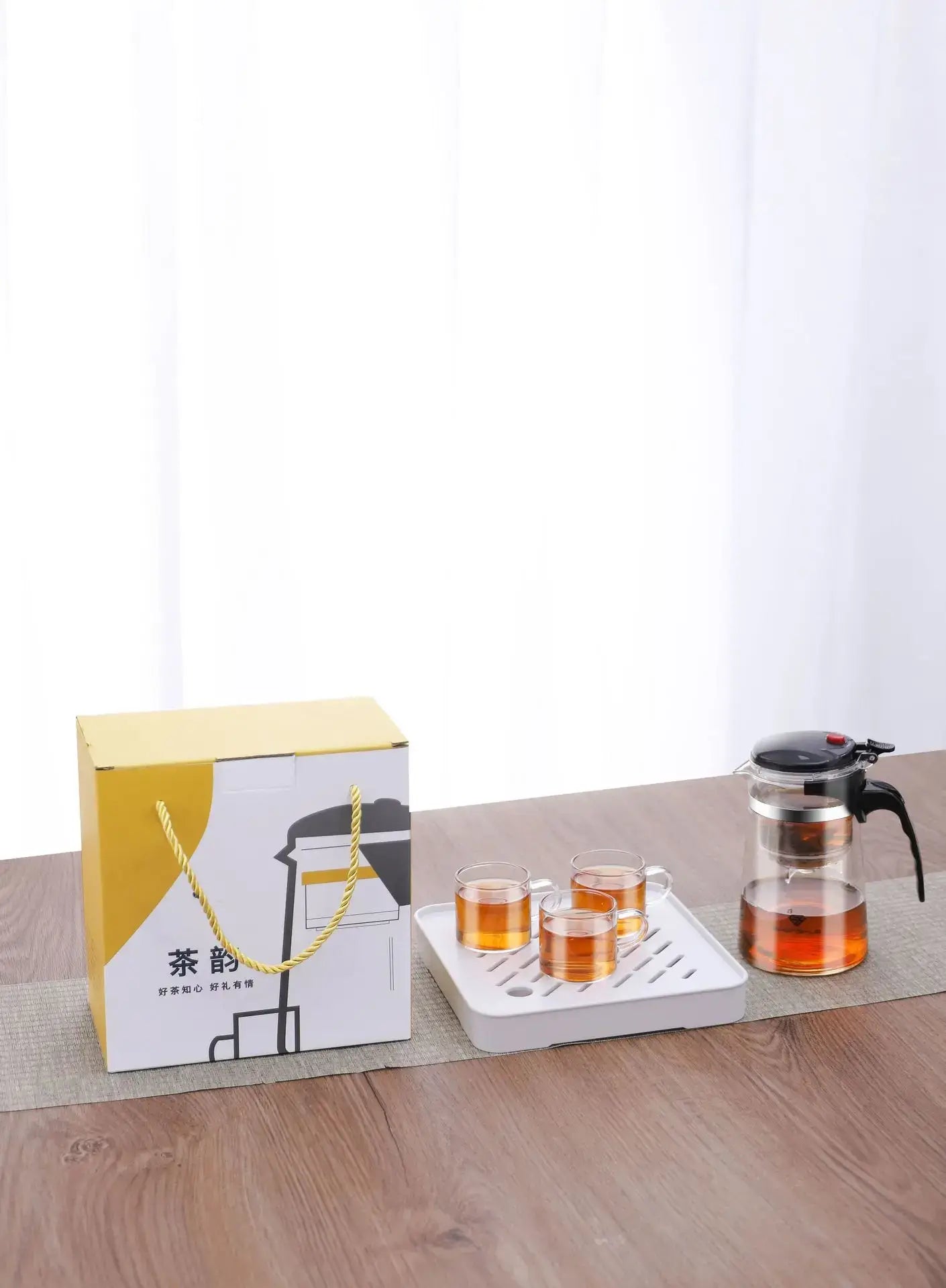 Glass Teapot 1L – Rich Aroma + One-Click Filter System glass teapot on table with three cups and gift box