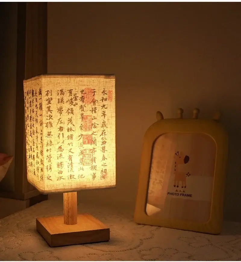 LED table lamp ambient glow with fabric shade and wooden base, providing soft ambient light at bedside.