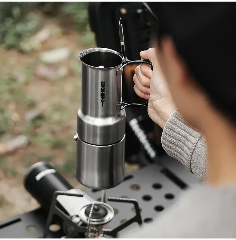 Stainless Steel Moka Pot – Rich Coffee + Foldable Handle being poured from a 350ml camping moka pot with foldable handle