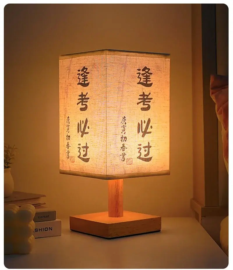 LED table lamp ambient glow with fabric lampshade and wooden base illuminating a bedside table.