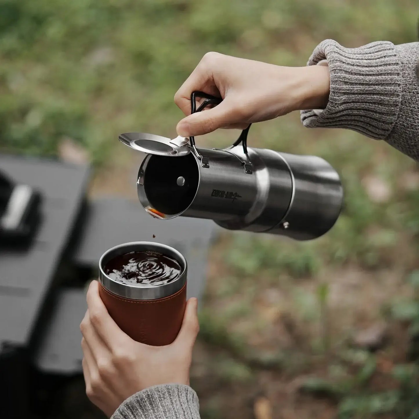 Stainless Steel Moka Pot – Rich Coffee + Foldable Handle pouring fresh moka coffee into a camping cup, 350ml compact stainless steel