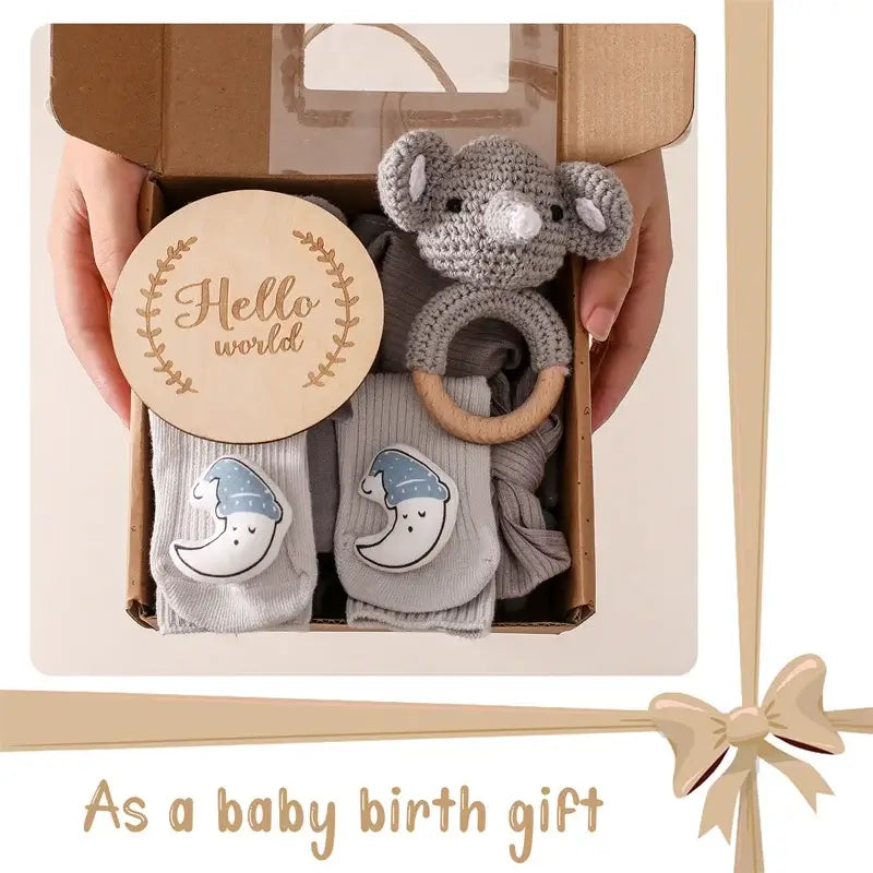 Baby bath gift set with milestone cards and wooden brush showing blanket, wooden brush, milestone disc, and knitted rattle in gift box