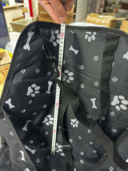 Pet Booster Seat – Safer Rides + Adjustable Seat Belt, black paw-print booster seat interior with measuring tape showing depth