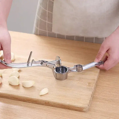 5 in 1 Garlic Press Nut Clip Bottle Opener Multifunction Manual Garlic Mincer Squeezer Handheld Kitchen Tools Kitchen Gadgets showing metal garlic press in use on cutting board