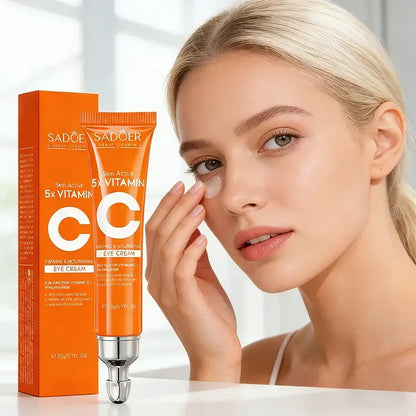 Brightening cream with vitamin-C for dark circles and puffiness — SADOER eye cream tube beside model applying under-eye