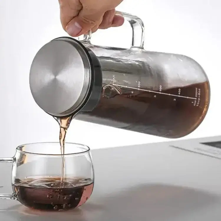 Cold Brew Coffee Maker – Keeps Aroma Fresh + 1.0L Glass Carafe pouring cold brew from airtight glass carafe with stainless steel lid and filter