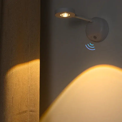 Motion sensor night light illuminating a wall with a soft glow, featuring a sleek design for bedrooms and kitchens.
