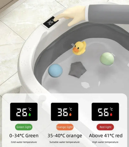Foldable baby bath tub with temperature display featuring a duck toy and color-coded indicators for water temperature.