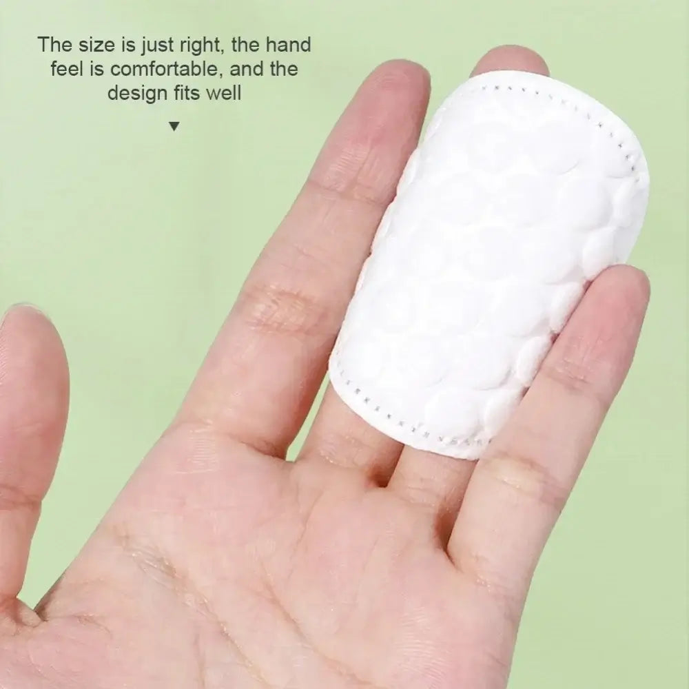 Dual-Sided  Gentle Makeup Removal Cotton Pads shown on fingertip, dual-textured plush and textured sides for makeup removal and cleansing