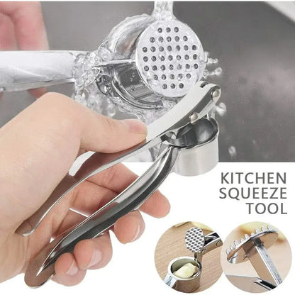 Garlic Press – Silky Mince For Effortless Prep + Heavy-Duty Zinc Alloy Construction stainless zinc alloy garlic crusher being rinsed under faucet