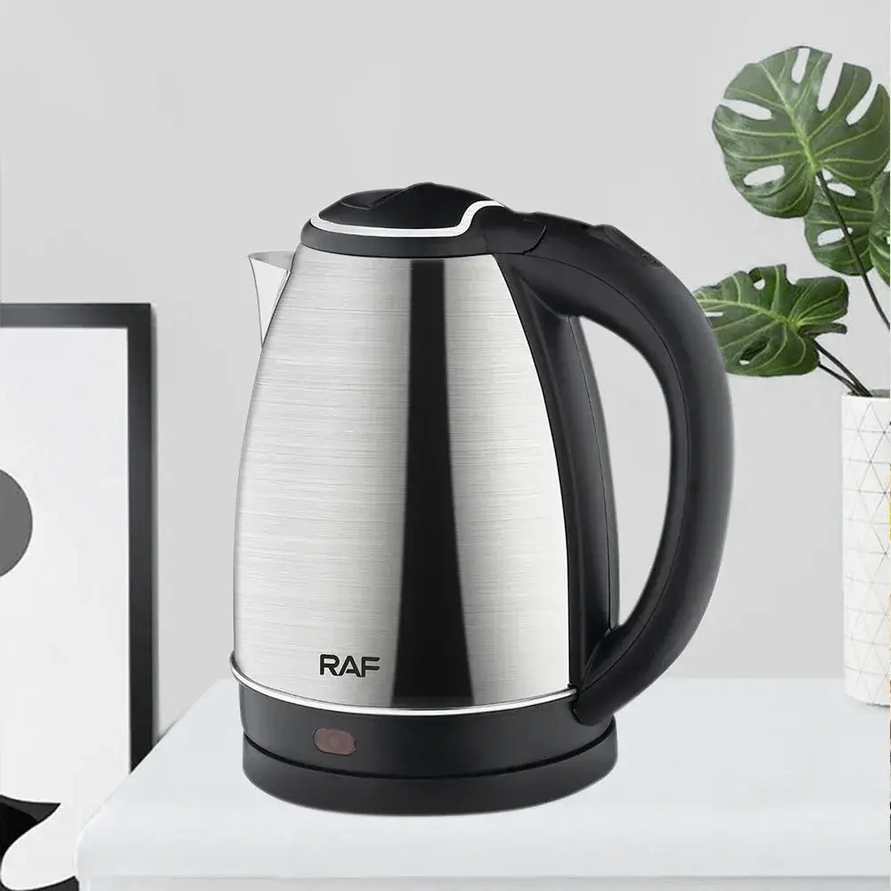 2L stainless steel electric kettle with black handle and base on a white kitchen counter.