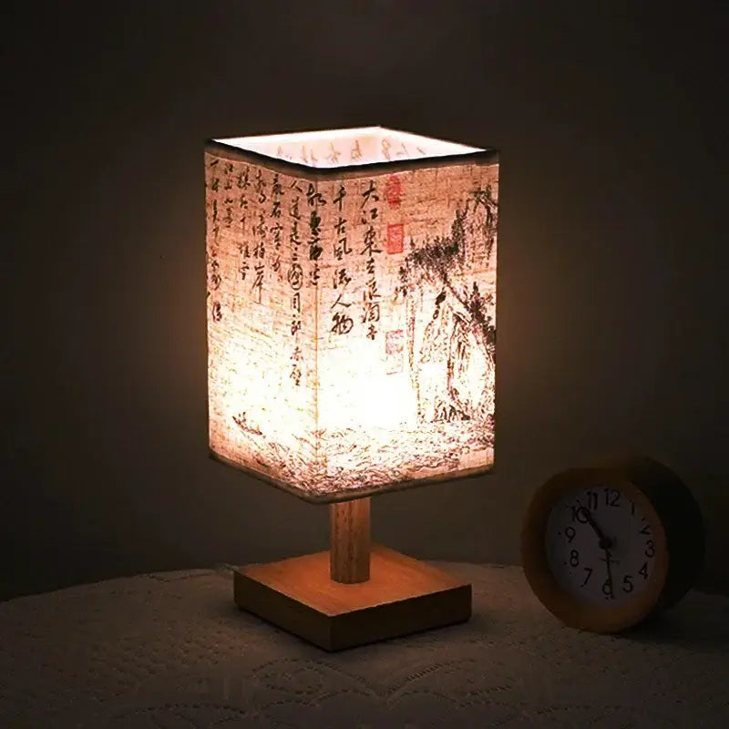 LED table lamp ambient glow with Chinese style fabric shade and wooden base, creating a warm bedside ambiance.