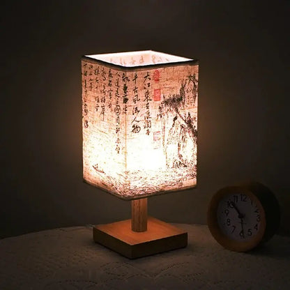 LED table lamp ambient glow with Chinese style fabric shade and wooden base, creating a warm bedside ambiance.
