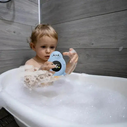 Baby Bath Thermometer - Accurate Readings + LED Display held by toddler in bubble bath, LED screen showing tub temperature