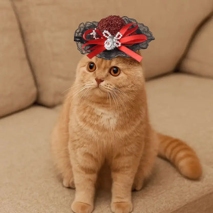 Pet Halloween Hat – Festive Shimmer + Adjustable Elastic Band For Cats And Small Pets; ginger cat wearing British-style sequin lace hat with red bow