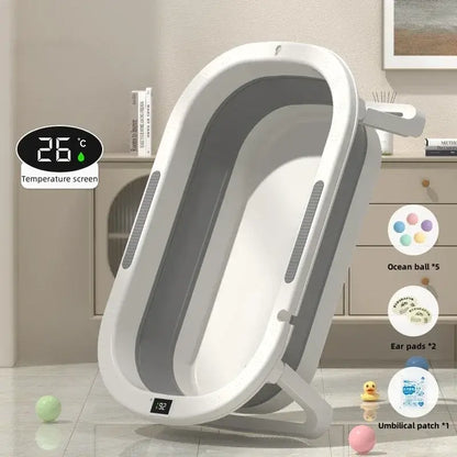 Foldable baby bath tub for toddlers with temperature display and accessories in a stylish bathroom setting.