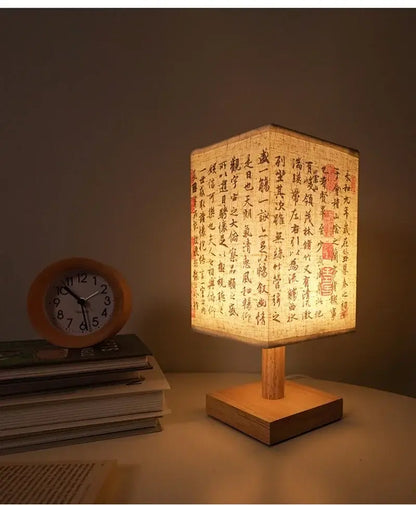 LED table lamp ambient glow with soft light, wooden frame, and fabric lampshade on a bedside table.