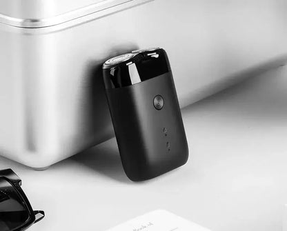 XIAOMI MIJIA S100 electric shaver with twin blades, black USB rechargeable, IPX7 waterproof on counter.