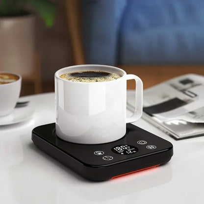 Portable coffee mug warmer with temperature control heating a white mug of coffee on a sleek black coaster.