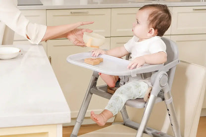 Baby Booster Seat – Mess-Free Dining + Foldable Portable High Chair For 6 Months To 3 Years showing infant eating in adjustable, easy-to-clean foldable high chair