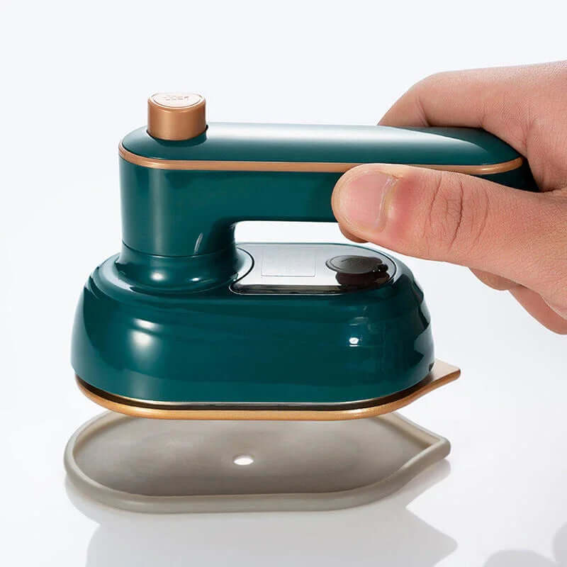 Garment Steamer – Wrinkle-Free Refresh On The Go + Foldable 180 Degree Rotating Head For Travel handheld green travel steamer shown with silicone mat