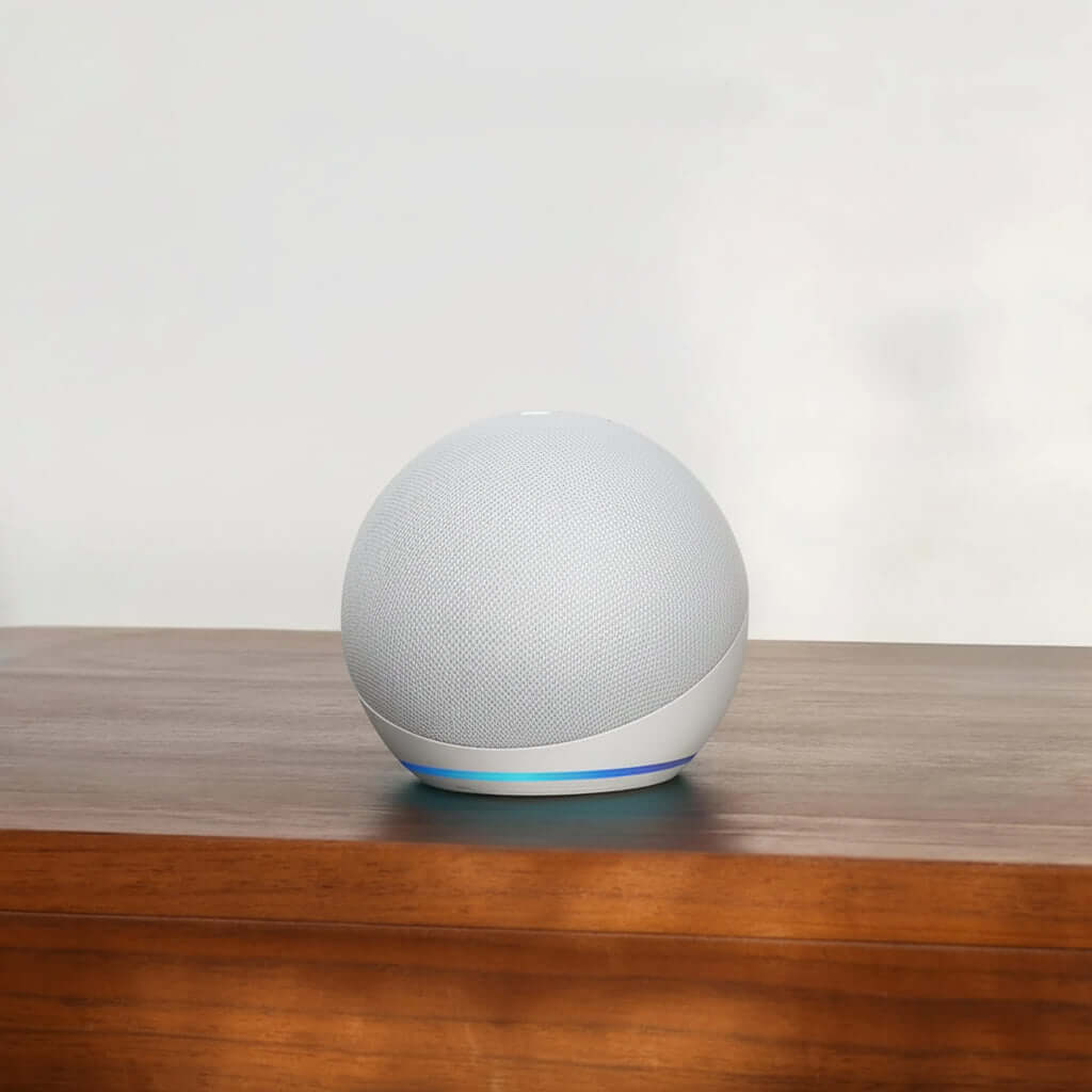 Echo Dot 5th Gen smart speaker on a wooden table, showcasing its sleek design and superior sound quality.