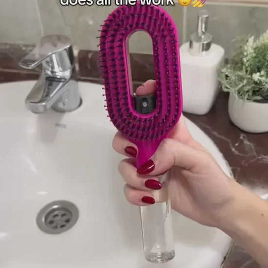 2-in-1 Spray Comb – Pain-Free Detangling for Smooth Hair handheld pink spray bottle comb with bristles and scalp massager over bathroom sink